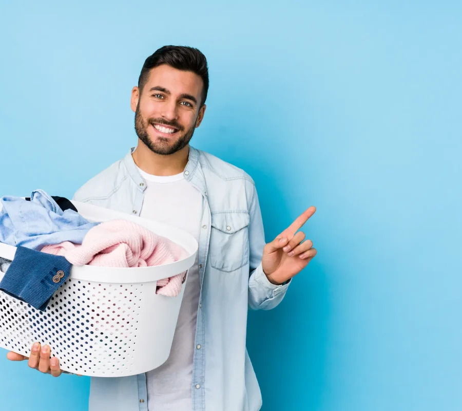 young-handsome-man-doing-laundry-isolated-smiling-pointing-aside-showing-something-blank-space young-handsome-man-doing-laundry-isolated-smiling-pointing-aside-showing-something-blank-space